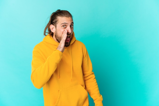 Young man with long hair look shouting excited to front.