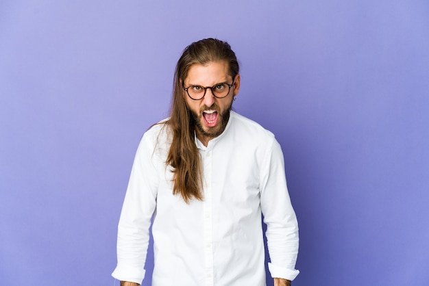 Young man with long hair look shouting very angry, rage concept, frustrated