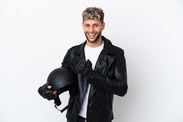 Young man with a motorcycle helmet isolated on white background celebrating a victory