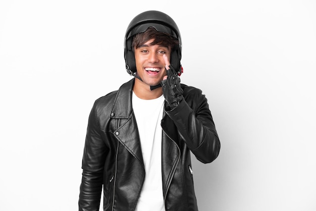 Young man with a motorcycle helmet isolated on white background shouting with mouth wide open