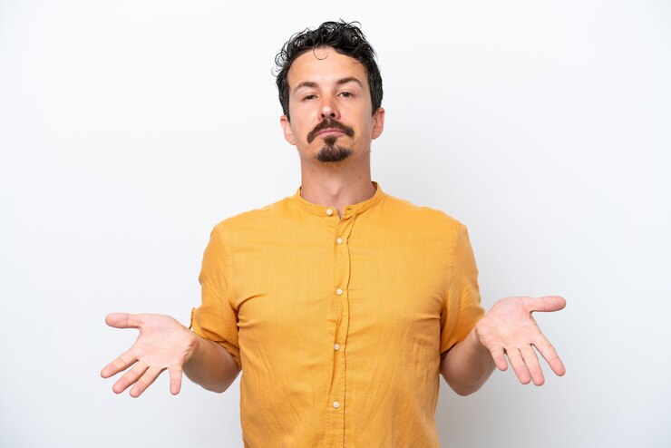 Photo young man with moustache isolated on white background having doubts