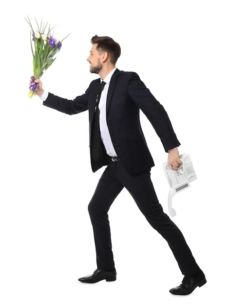 Young man with phone and flowers running