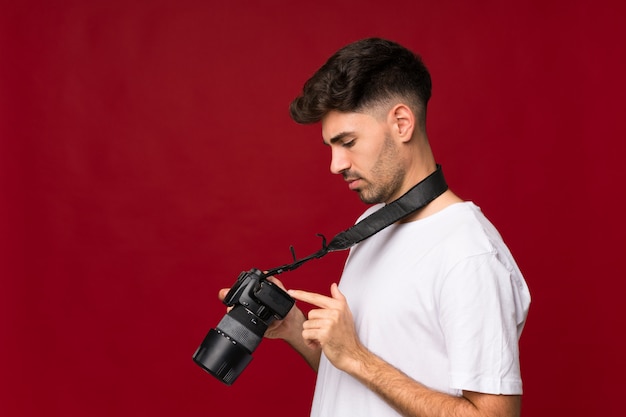 Young man with a professional camera