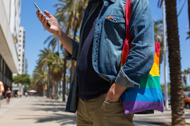 Young man with rainbow reusable bag