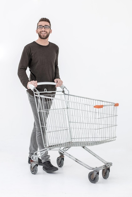 Young man with a shopping cart steps forward