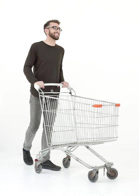 Young man with a shopping cart steps forward