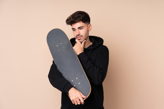 Young man with a skate and looking lateral