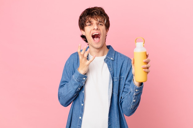 Young man with a smoothy looking desperate, frustrated and stressed