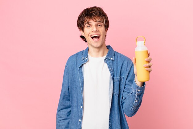 Young man with a smoothy looking happy and pleasantly surprised