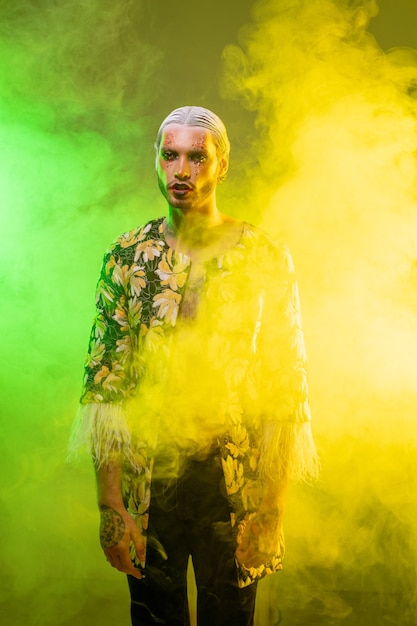 Young man with stage makeup, white hair in accurate hairdo and tattoo on hands