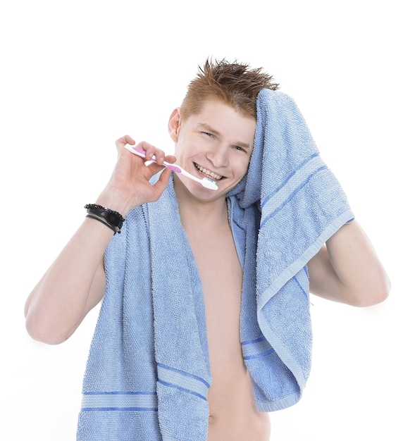 Young man with towel and toothbrush.