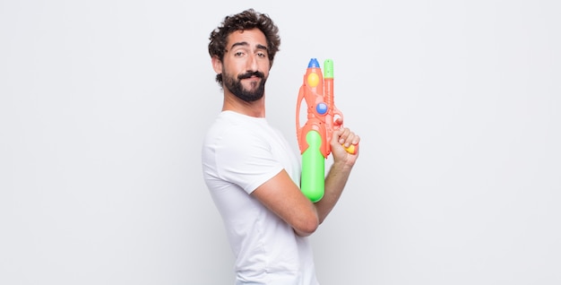 Young man with a water gun