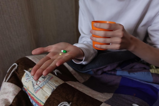 A young man with white hair is ill and is taking pills