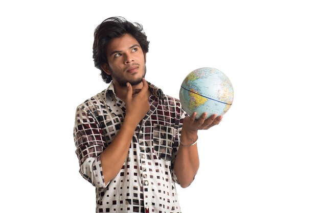 Young man with a world globe on a white.