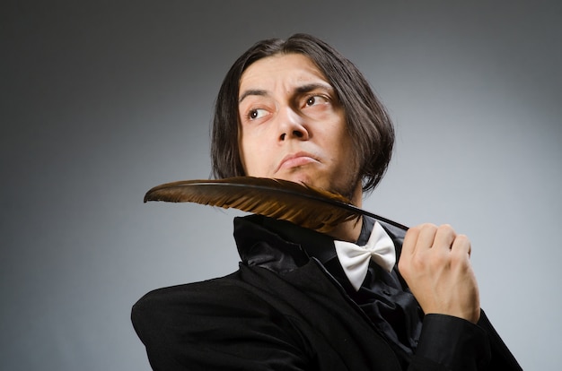 Young man with writing feather