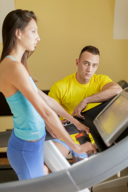 Young man and woman in the gym