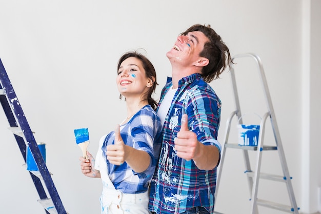 young man and woman in love and painting the wall