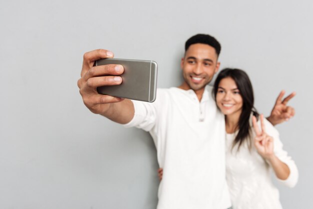 Young man and woman making photo