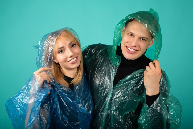 Young man and woman in raincoats