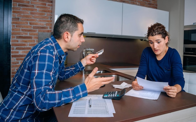 Young man and woman sitting on table