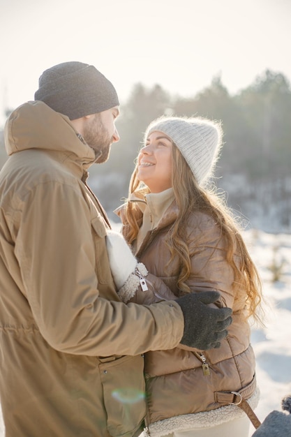 Young man and woman spending time together at winter day