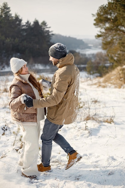 Young man and woman spending time together at winter day