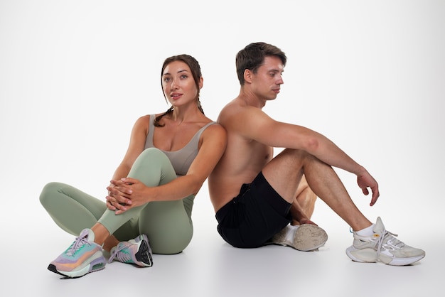 Young man and woman training together for bodybuilding