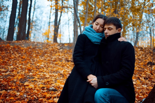 Young man and woman in warm autumn clothes, cashmere coat