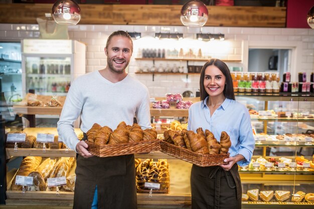 Young man and woman with croissants in a bakery