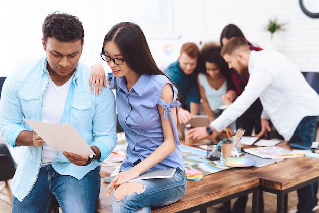 Young man and woman working together in the office.