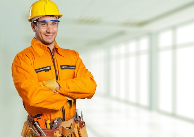 Young man in work uniform and yellow helmet