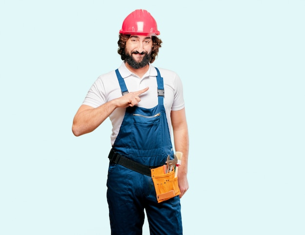 Young man worker pointing to the side