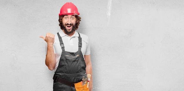 Young man worker pointing to the side