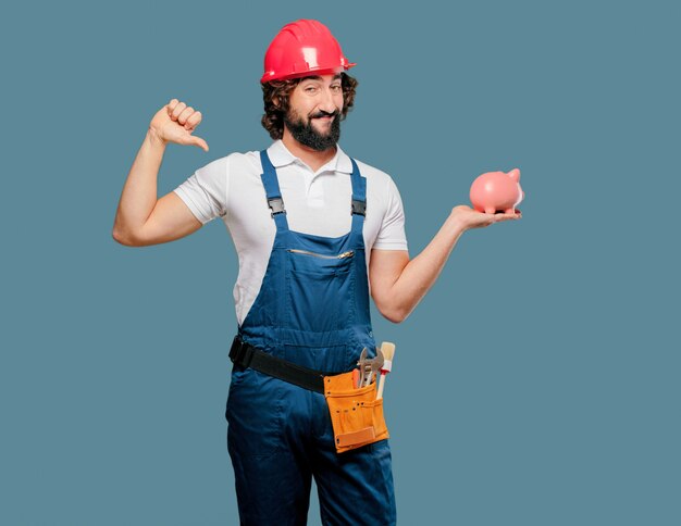 Young man worker with a piggy bank 