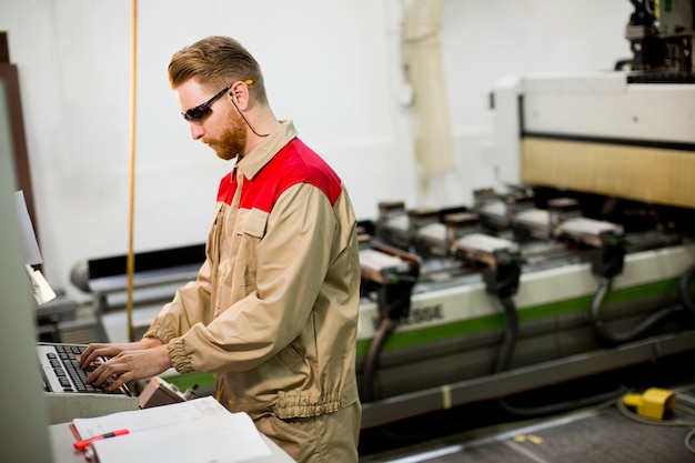 Young man working in the factory