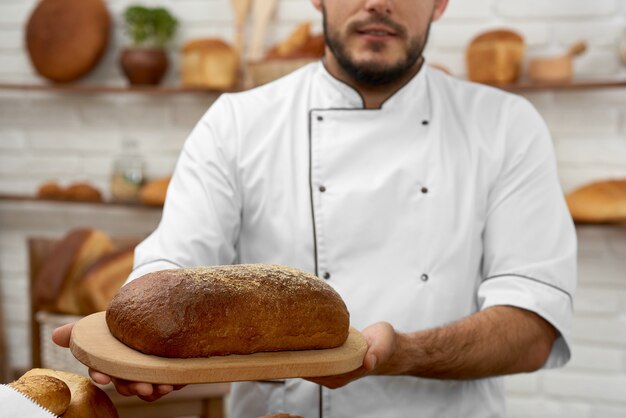 Young man working at his bakery