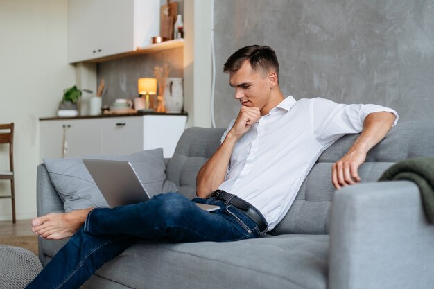 Young man working on a laptop in living room