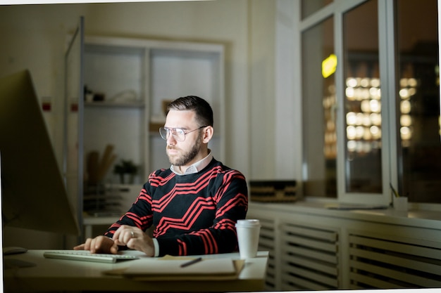 Young man working late in office