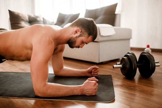 Young man working out at home