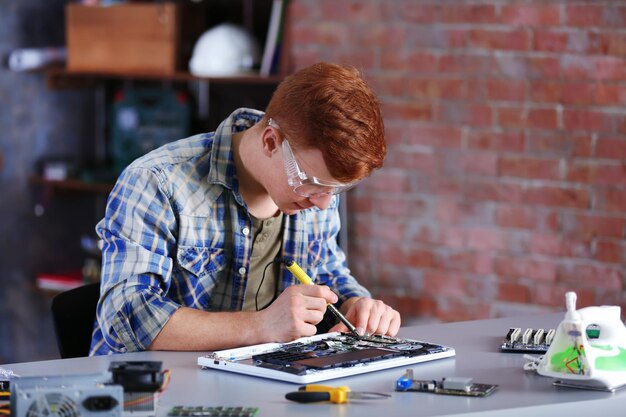 Young man working in repair center