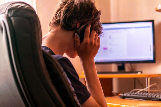 Young man working with computer and typing on a keyboard at home, freelancer concepts