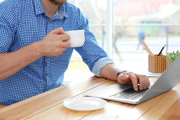 Young man working with laptop in office