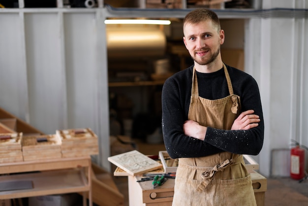 Young man working in a wood engraving workshop