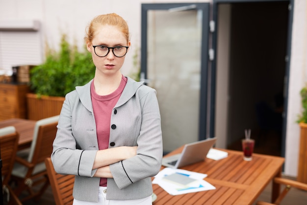 Young manager standing in cafe