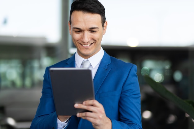 Young manager using a digital tablet outdoor