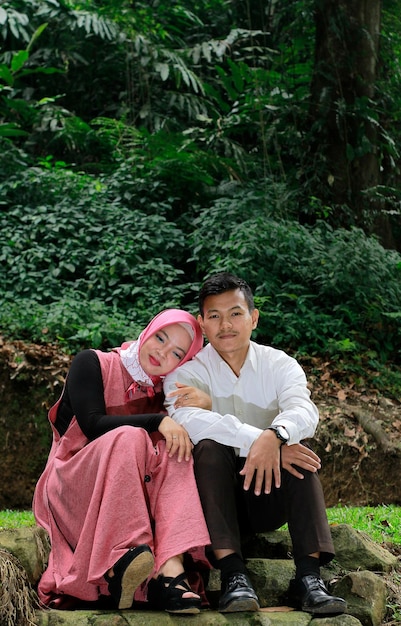 young married couple enjoying each other's photo in the forest