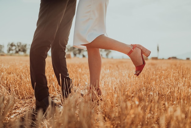 a young married couple in a large field enjoys the sunset. Selective focus. High quality photo