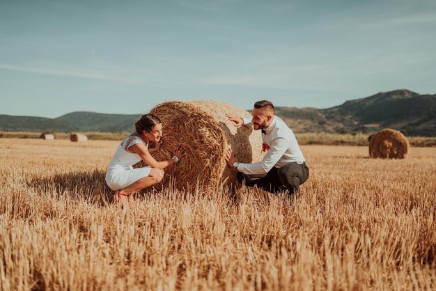 a young married couple in a large field enjoys the sunset. Selective focus. High quality photo