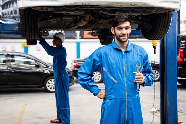 Young mechanic holding a wrench