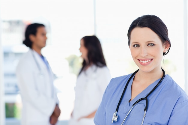 Young medical intern looking at the camera with a beaming smile